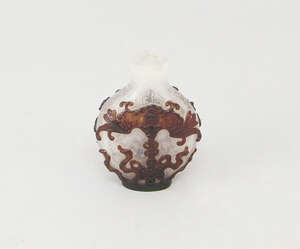 
	
		A Chinese carved cameo glass snuff bottle, decorated with suspended bats and ribbon tied...