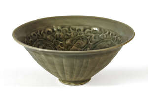 A Chinese Yaozhou celadon glazed conical bowl, carved to the inside with meandering flowering lotus stems, decorated with spiral fluting to the exterior, 11cm 