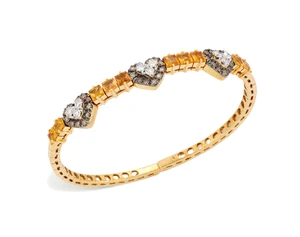 A diamond and yellow sapphire torque bangle, the upper half designed as three brilliant-cut...