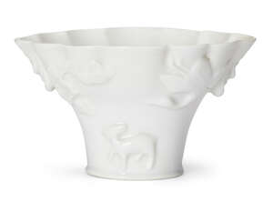 
	
		A Chinese Dehua porcelain moulded libation cup, late Qing/Republic, moulded with a...