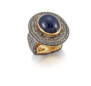 A cabochon sapphire and diamond ring, the central collet-set cabochon sapphire with pave single-cut diamond border and shoulders, ring size O
