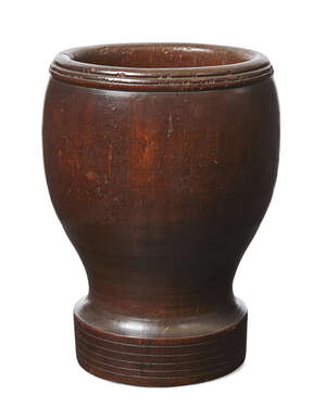 
	
		An American turned treen mortar, 19th century, with moulded rim, the foot with five...