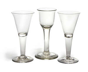 
	
		A pair of George III wine glasses, with inverted trumpet shaped bowls, to hollow tapering...