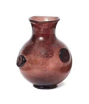
	
		A manganese glass vase, probably late Roman, of globular form with narrow neck and wide...