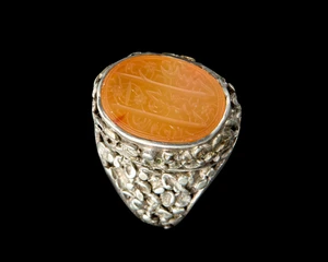 A Qajar ring set with Safavid carnelian seal,Iran, 16th and 19th century 
In floral silver...
