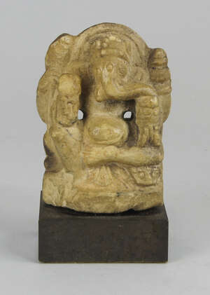 A marble figure of Ganesha, 18th century, modelled seated cross legged with auspicious objects...