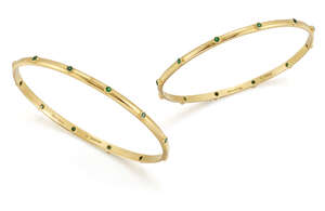 
	
		Theo Fennell, a pair of gold and emerald bangles, each accented with circular-cut...