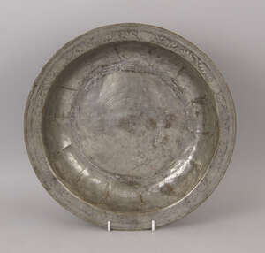 
	
		An Ottoman circular tin plated copper dish, 18th century, the rim engraved with trailing...
