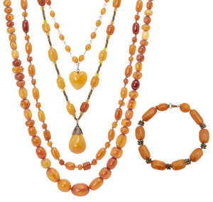 
	
		A collection of amber jewellery, early 20th century, comprising four bead necklaces and a...