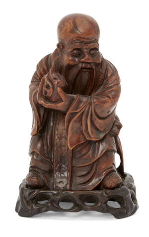 
	
		A Chinese hardwood figure of Shou Lao, 19th century, carved holding a peach and standing...
