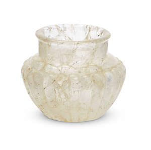 A rock crystal vase, possibly Bactrian, the body with raised lobed decoration tapering to the flat base, the rounded rim everted, with short straight neck, 9.3