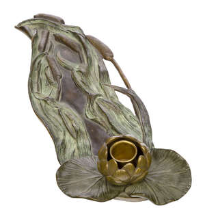 
	
		An Art Nouveau patinated bronze candle holder  
		c.1900, indistinct stamped mark  
		