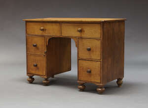 
	
		An oak knee hole desk, late 19th, early 20th Century, the rectangular top above an...
