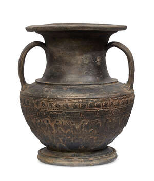 An Etruscan Bucchero amphora, circa 6th century B.C., on a short spreading foot with curved handle either side joining the neck to the upper shoulder, the sphe