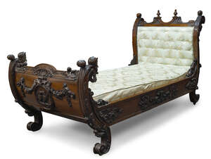
	
		An Italian carved walnut day bed, late 19th Century, the curved headboard surmount with...