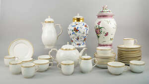 A KPM porcelain part tea/coffee service, moulded and gilt in the 18th century taste, with panels of Rococo flowers, to comprise a coffee pot, a tea pot, a suga