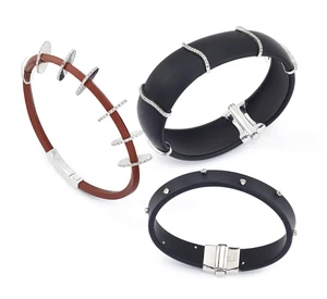 A group of three rubber bracelets, in black and brown rubber, each with applied brilliant-cut...