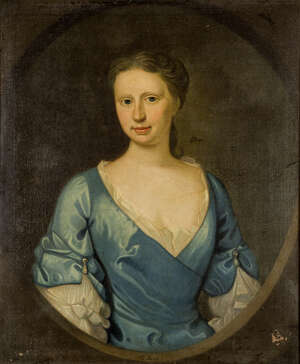 British School, 
		 
		early 18th Century- 
		 
		Portrait of Mrs Thomas Hext, née Gertrude Hawkins (1698-1786) half-length in a blue dress, within a fe