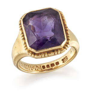 An 18ct gold and amethyst single stone ring, the cut-cornered rectangular amethyst in collet...