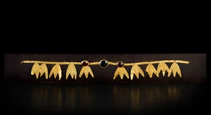 A Greek style gold &lsquo;diadem&rsquo; inlaid with three oval cabochons set centrally, with ten laurel...