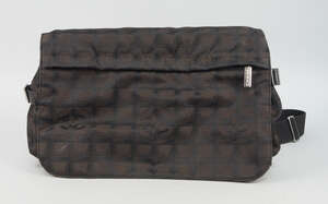 
	
		A Chanel Travel Line messenger bag, dark bronze monogram nylon, flap front with zip...