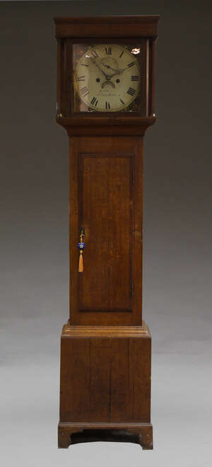 
	
		An oak longcase clock, 19th Century, with plain hood, the trunk with crossbanded door on...