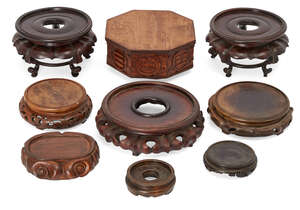 
	
		Nine Chinese hardwood stands, 19th-20th century, 9-19cm diameter
		Provenance: Justus...