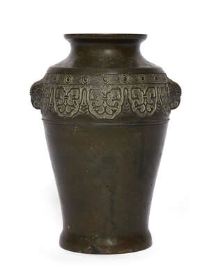
	
		A Japanese archaistic bronze vase, 19th century, with two bird mask handles to the...