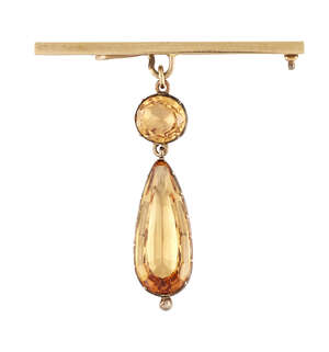 
	
		An early 19th century topaz pendant, the pear shaped pale orange topaz drop with oval...