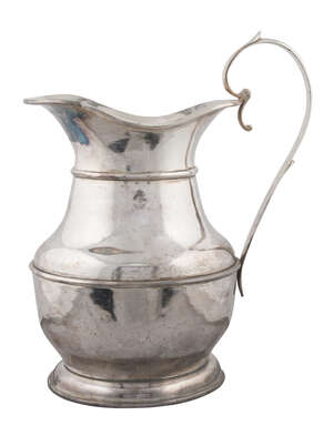 A massive Georgian polished metal jug, of ovoid baluster form, with scroll handle and engraved crest, total height 54cm