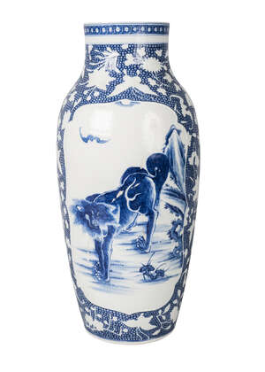 A Chinese soft-paste porcelain vase, 18th century, painted in underglaze blue with two panels decorated with lions and bats, on a ground moulded in light relie