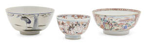 
	
		Three porcelain bowls, 17th-19th century,  comprising a Chinese famille rose punch bowl,...
