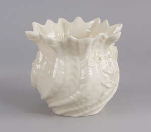 A modern Belleek vase, 20h century, modelled with a petalled rim and writhen form body, applied with clover and rose decoration, green printed mark to base, 10