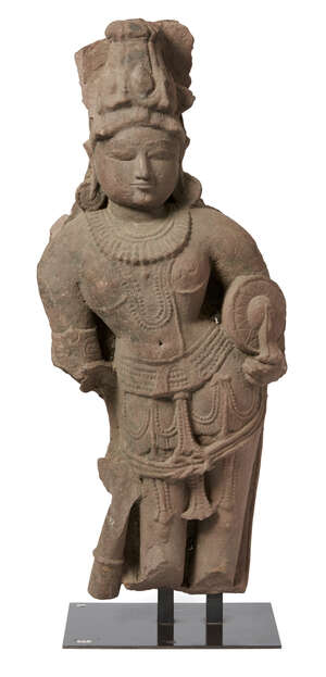 A Central Indian mottled red sandstone figure of Vishnu, 10th-11th century, carved in swaying position, naked except for a sash and jewellery, the face with al