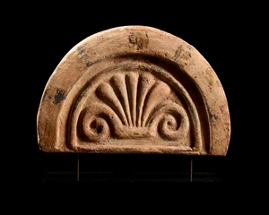 An Etruscan terracotta antefix,circa 6th Century B.C.,
the central palmette within an arched...