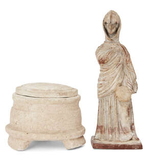 A reproduction Greek style Tanagra figure, the standing female figure enveloped in a himation and holding a fan in her left hand, Not Ancient, 18.5cm high and 
