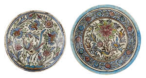 
	
		Two Qajar pottery dishes with birds and flowers, Iran, late 19th-early 20th century, of...