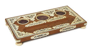 
	
		An Anglo Indian sandalwood and ivory mounted ink stand, 19th century, with three vacant...