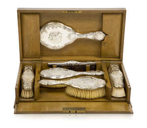 An Edwardian Silver dressing table set in fitted oak box
		Silver with mark of Henry Matthews, Birmingham hallmarks 1901, 1902, 1904, box marked Walker & Hall