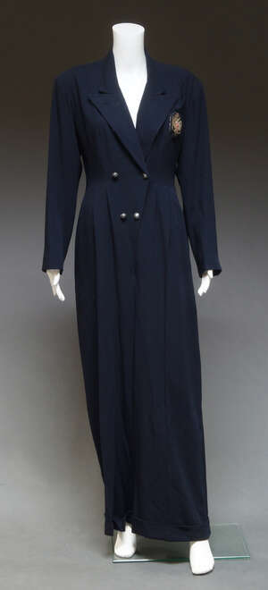 
	
		Jean Paul Gaultier, a navy blue boiler suit, with metal thread embroidered badge to...