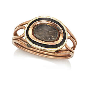 
	
		An early 19th century gold, mourning ring, the oval bezel with glazed locket compartment...