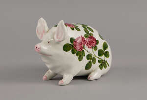 A small Wemyss pig, decorated with chrysanthemums and foliage, marked Wemyss, with printed mark to base, 16cm long