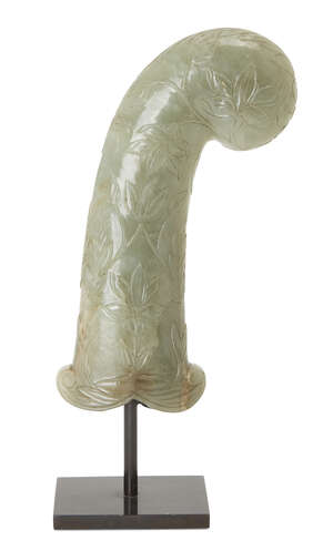 
	
		A Mughal carved green jade hilt, India,18th century, of pistol grip form, carved with...
