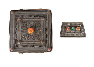 
	
		A Tibetan silver and wood backed Gau and a similar buckle, 19th century, the Gau filigree...