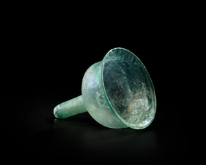 A Byzantine pale blue glass stemmed lamp insertcirca 6th Century A.D.,
With stand,
10.5cm...