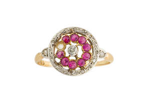 
	
		An early 20th century gold, synthetic ruby and diamond circular cluster ring, the...