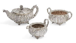 
	
		A three-piece tea set, comprising a George IV melon shaped teapot and milk jug, both...