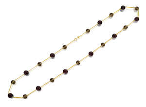 A garnet and smoky quartz necklace, composed of a line of alternate garnet and smoky quartz beads with fancy chain links between, length 59.0cm