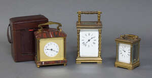 
	
		A French red marble and gilt brass carriage clock, the white enamel dial with Arabic...