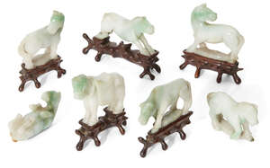 
	
		A set of seven Chinese jadeite hoses, early 20th century, carved in various poses, on...